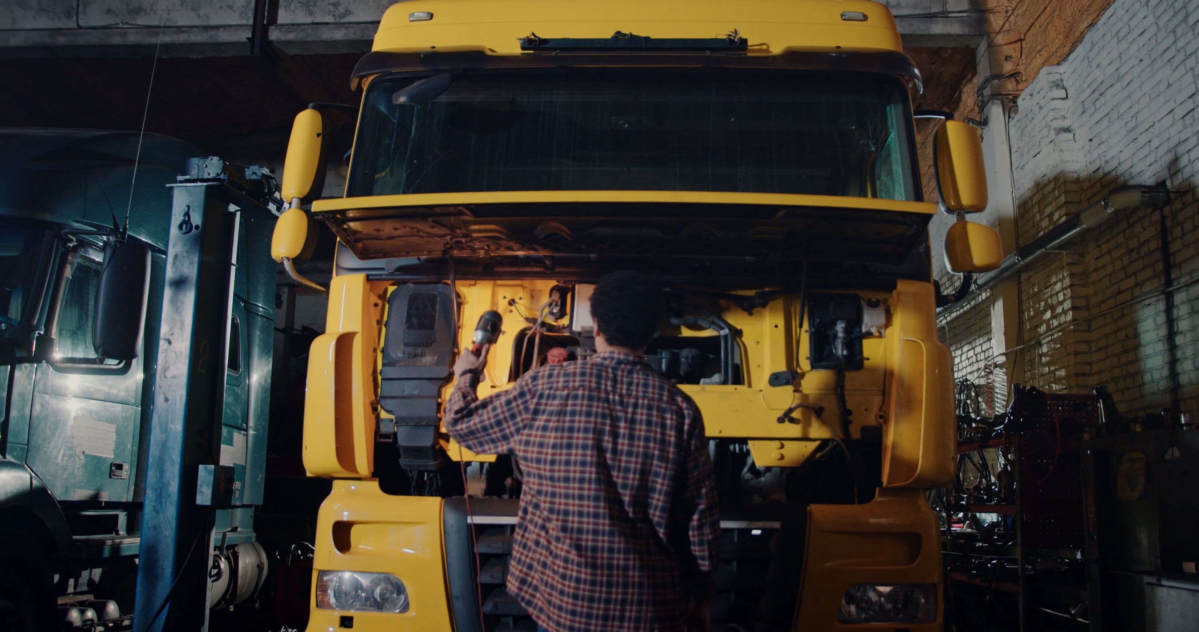 Mechanic checking a truck engine